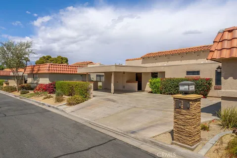 a view of a swimming pool with a table chairs and a fire pit