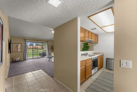 a kitchen with stainless steel appliances granite countertop a sink a stove and a microwave