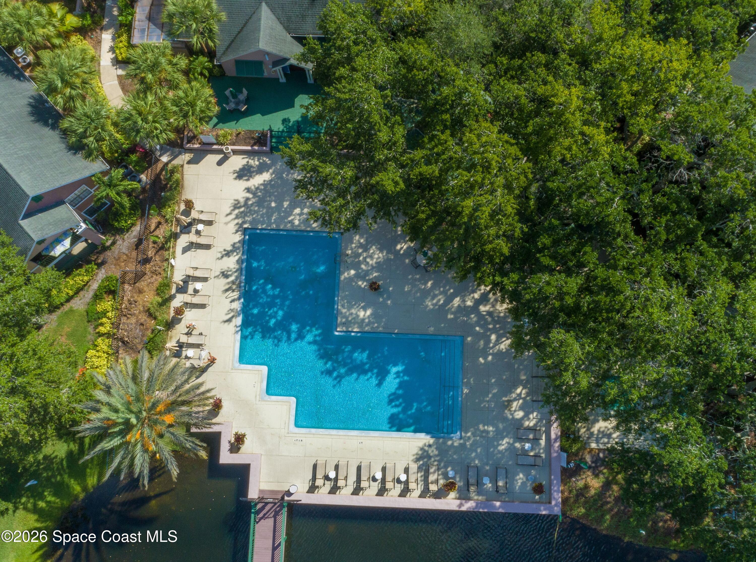 7667 North Wickham Road, Unit 102 Melbourne, FL 32940 - Photo 14 of 15 an outdoor space with seating area and trees