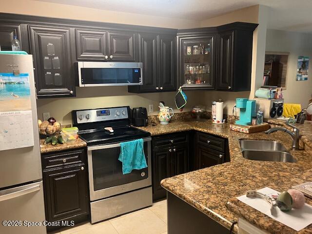 7667 North Wickham Road, Unit 102 Melbourne, FL 32940 - Photo 2 of 15 a kitchen with stainless steel appliances granite countertop a stove a sink and a microwave