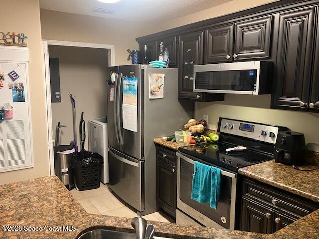 7667 North Wickham Road, Unit 102 Melbourne, FL 32940 - Photo 3 of 15 a kitchen with stainless steel appliances granite countertop a refrigerator stove and microwave