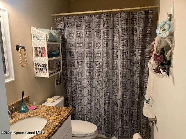 7667 North Wickham Road, Unit 102 Melbourne, FL 32940 - Photo 7 of 15 a bathroom with a granite countertop sink toilet and shower