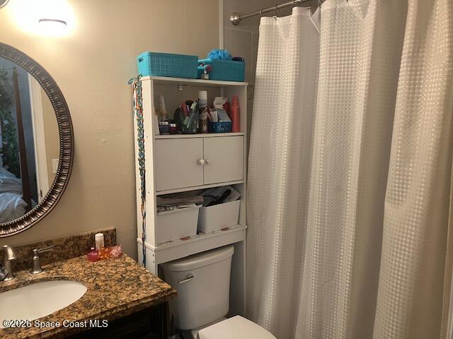 7667 North Wickham Road, Unit 102 Melbourne, FL 32940 - Photo 8 of 15 a bathroom with a sink toilet and mirror