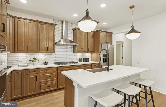 a kitchen with a sink a stove and chairs