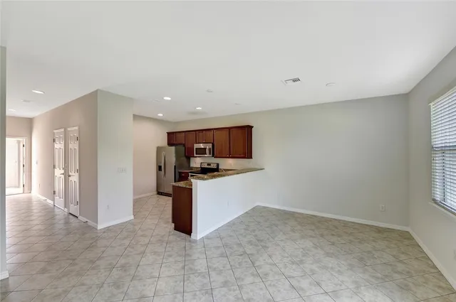 a view of kitchen with refrigerator and window