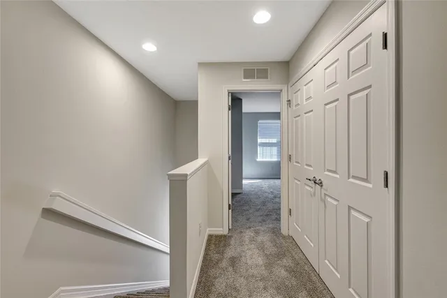 a view of a hallway with white walls