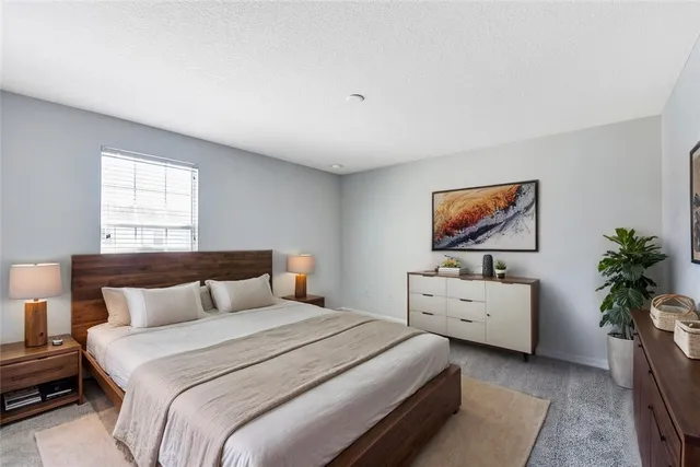 a bedroom with a bed and a flat screen television