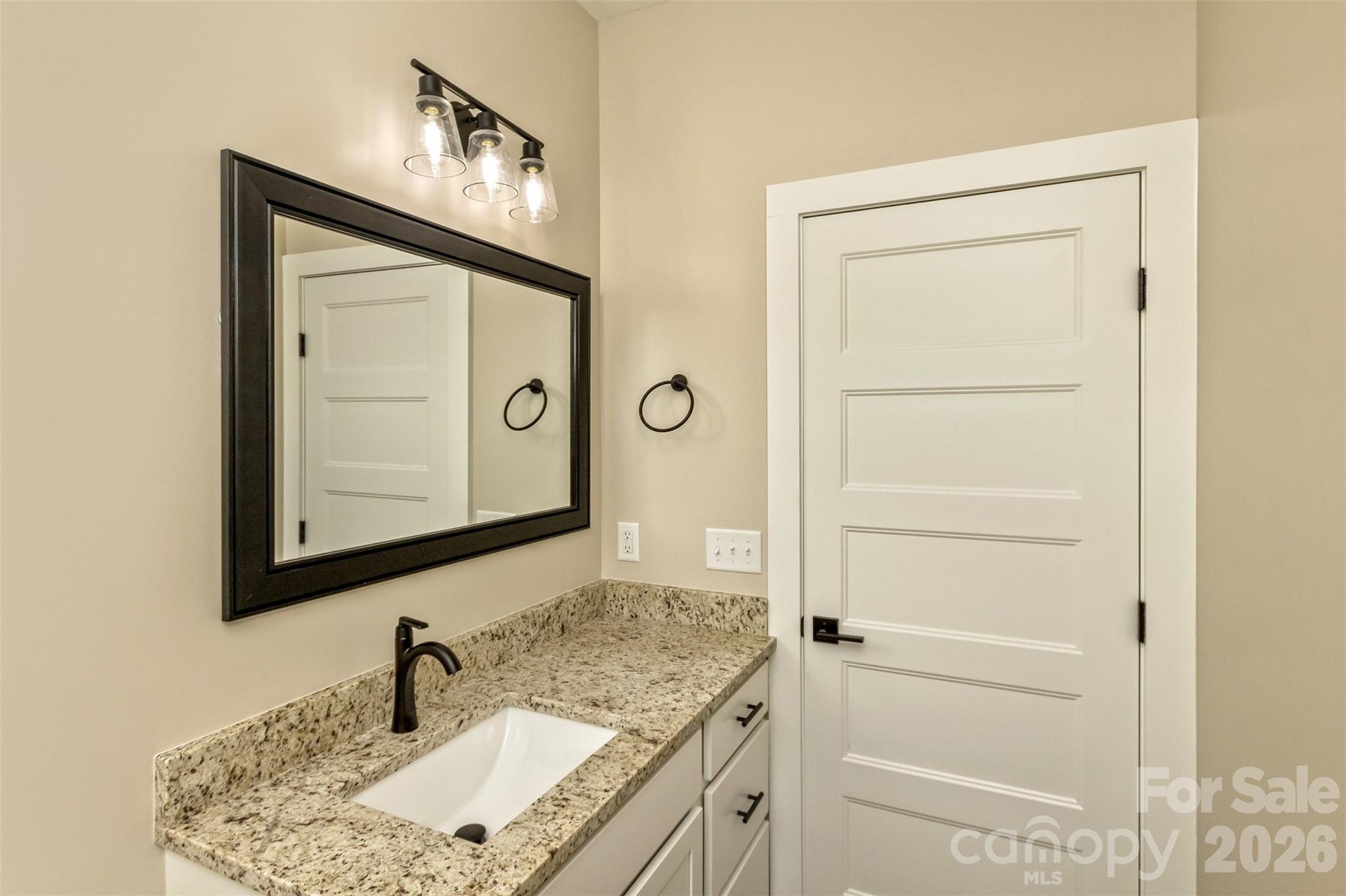 112 Peyton Elaine Road Clyde, NC 28721 - Photo 21 of 35 a bathroom with a granite countertop sink and a mirror