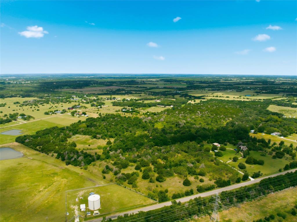 663 North Katy Road Elm Mott, TX 76640 - Photo 3 of 25 Beautiful rural landscape featuring a mix of open fields and densely wooded areas