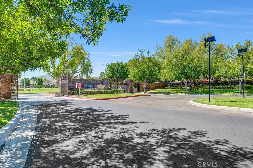 11499 Bridgeway Drive Riverside, CA 92505 - Photo 68 of 70 a view of a swimming pool with a yard and trees in the background