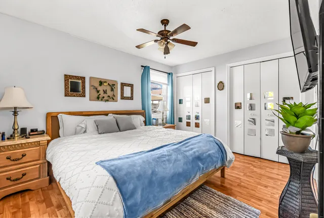 a bedroom with a large bed and a chandelier