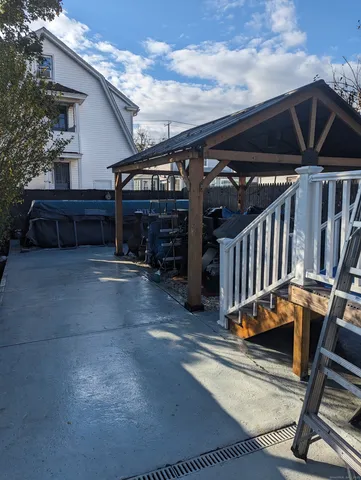a view of a garage with wooden deck