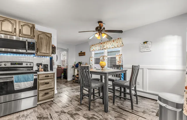 a view of a dining room with furniture window and wooden floor