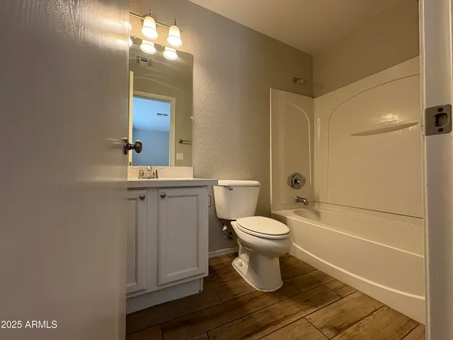 a bathroom with a toilet a sink and shower