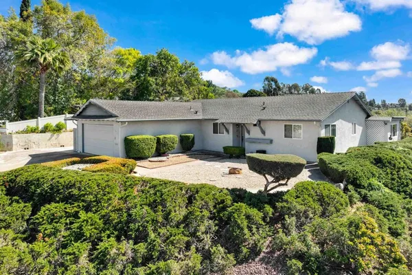 a view of a house with pool and a garden