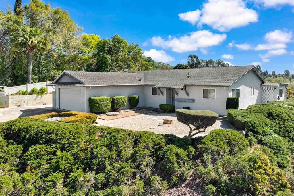 a view of a house with pool and a garden