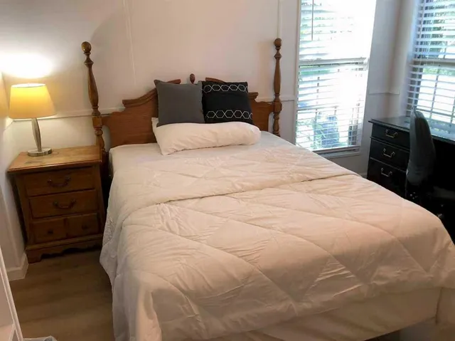 a bedroom with a bed and window