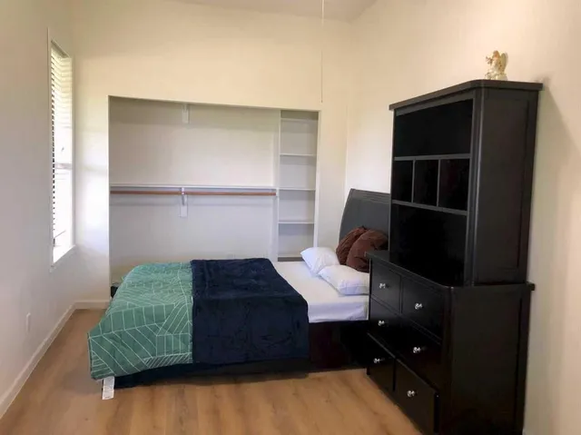 a bedroom with a bed and window