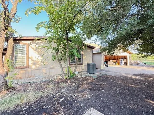 a view of a house with a yard and tree