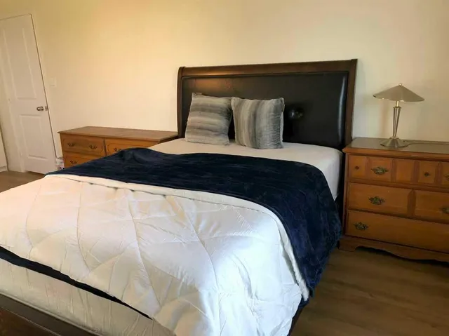 a bedroom with a bed and a closet