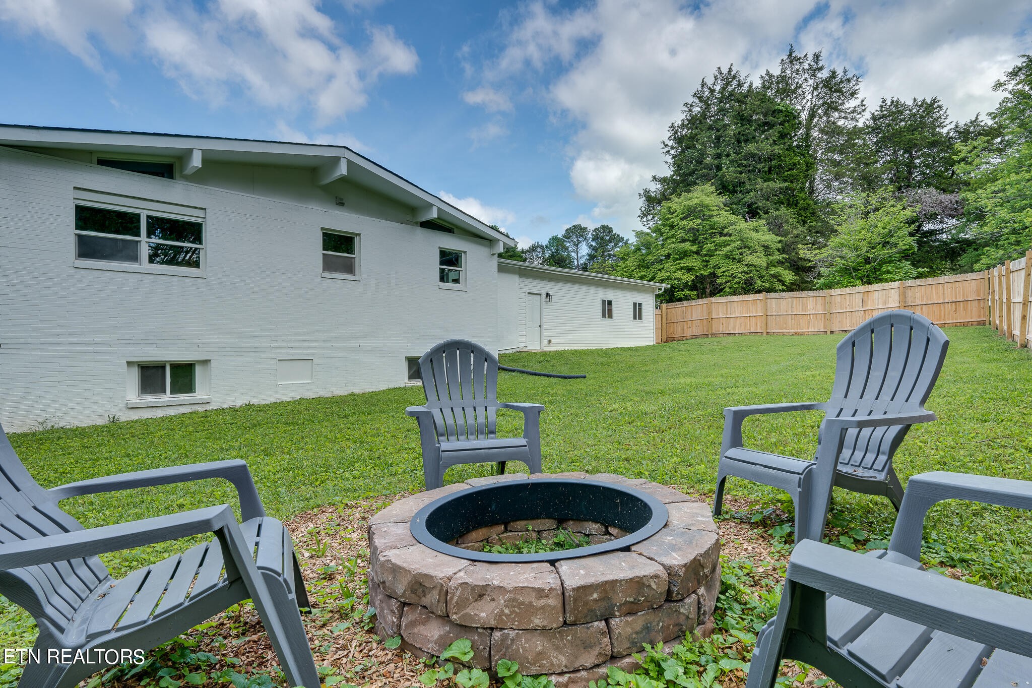117 Columbia Drive Oak Ridge, TN 37830 - Photo 55 of 60 a backyard of a house with garden and outdoor seating