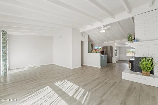 a view of a kitchen with furniture and wooden floor