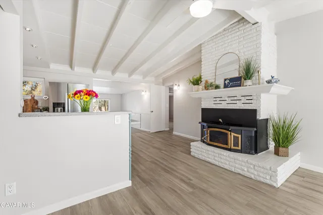 a view of living room with furniture and a fireplace