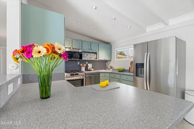 a kitchen with stainless steel appliances a refrigerator and a sink