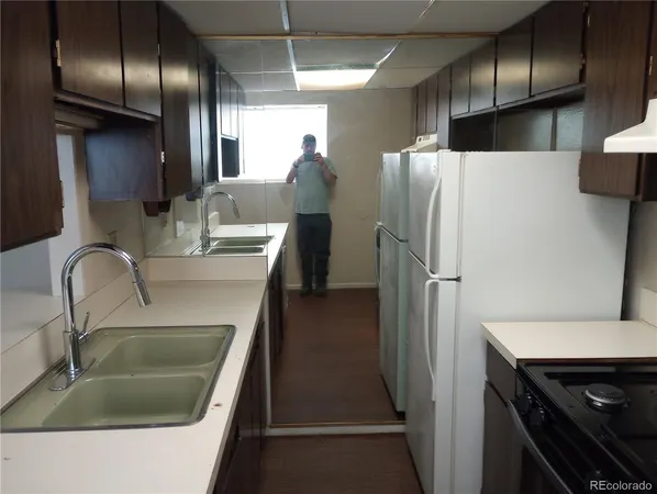 a kitchen with a refrigerator and a sink