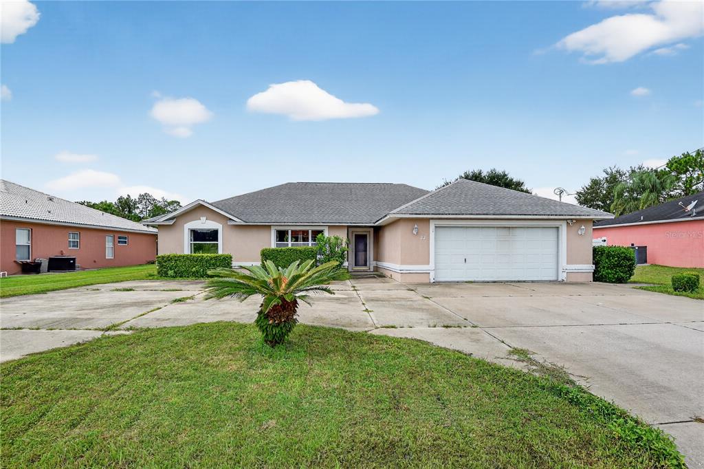 a front view of a house with a garden and yard