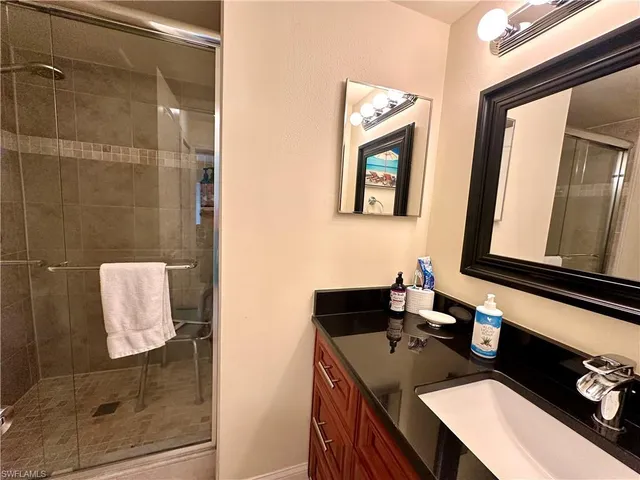 a bathroom with a sink vanity and a mirror