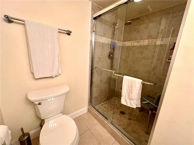 a bathroom with a toilet and a shower