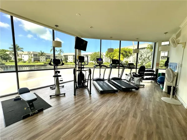 a view of a living room with furniture and floor to ceiling windows