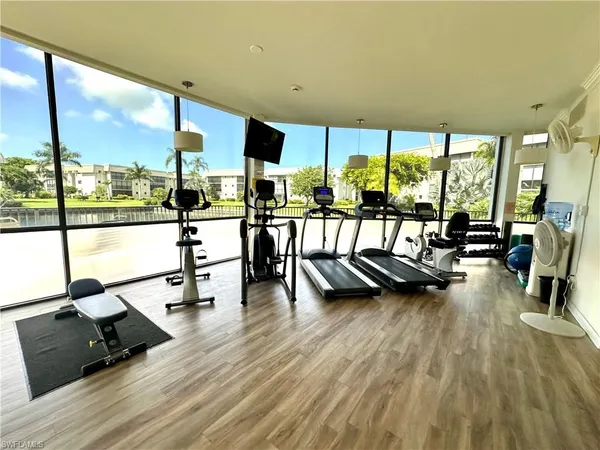 a view of a living room with furniture and floor to ceiling windows