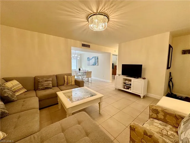 a living room with couches and a flat screen tv