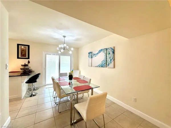 a dining room with furniture and a chandelier
