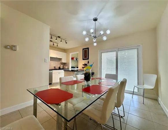 a view of a dining room with furniture and a chandelier