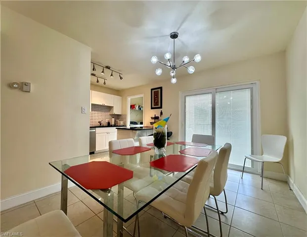 a view of a dining room with furniture and a chandelier