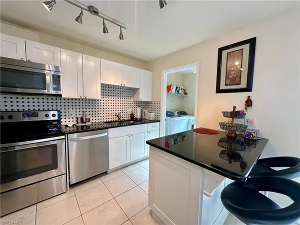 a kitchen with granite countertop a sink and stove