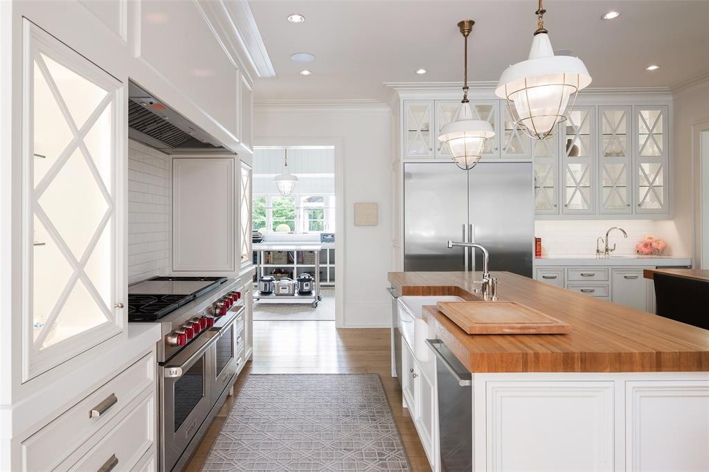 17 Robledo Drive Dallas, TX 75230 - Photo 11 of 40 a kitchen that has a lot of white cabinets and stainless steel appliances