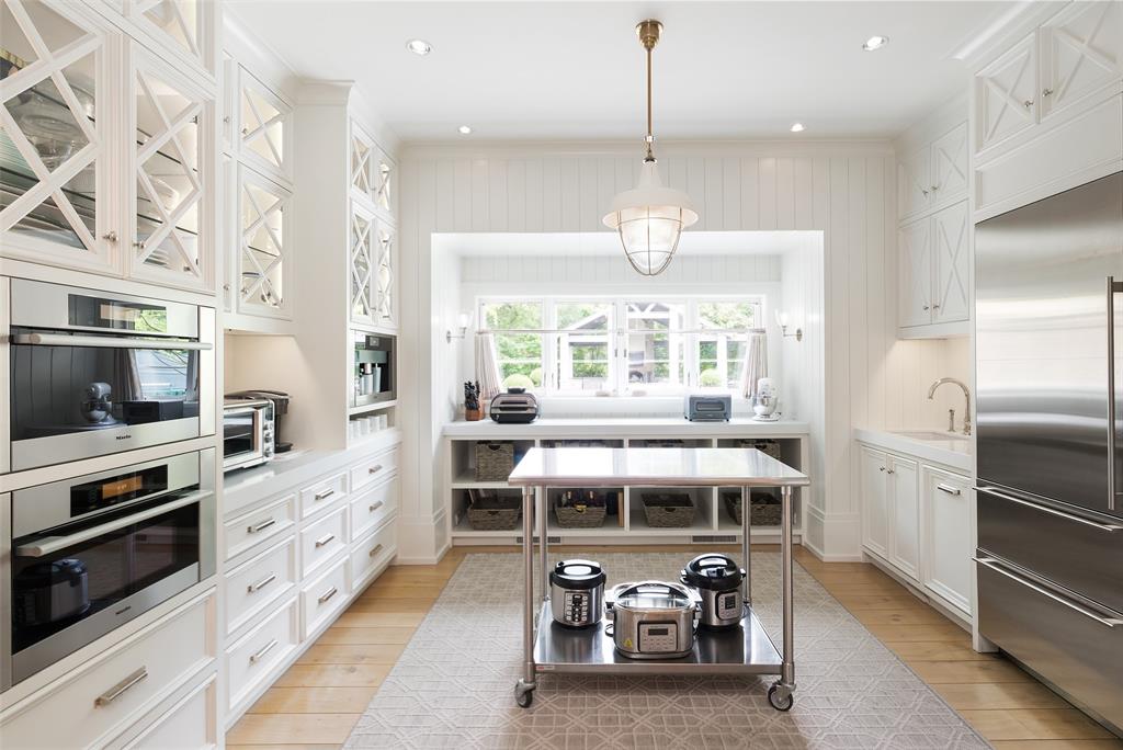 17 Robledo Drive Dallas, TX 75230 - Photo 12 of 40 a kitchen with stainless steel appliances kitchen island granite countertop a refrigerator and a stove top oven