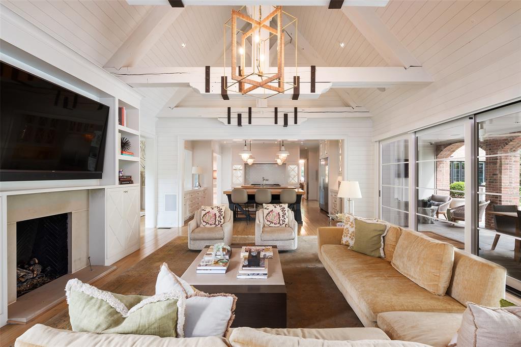 17 Robledo Drive Dallas, TX 75230 - Photo 14 of 40 a living room with furniture a fireplace and a flat screen tv