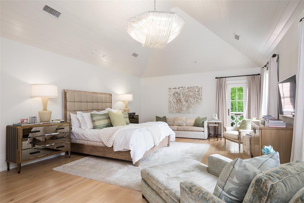 17 Robledo Drive Dallas, TX 75230 - Photo 18 of 40 a bedroom with a bed couches and a large window with wooden floor