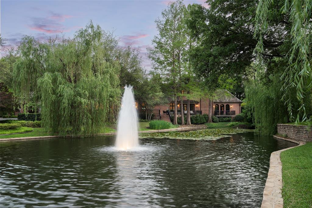 17 Robledo Drive Dallas, TX 75230 - Photo 4 of 40 a view of a lake with a house in the background