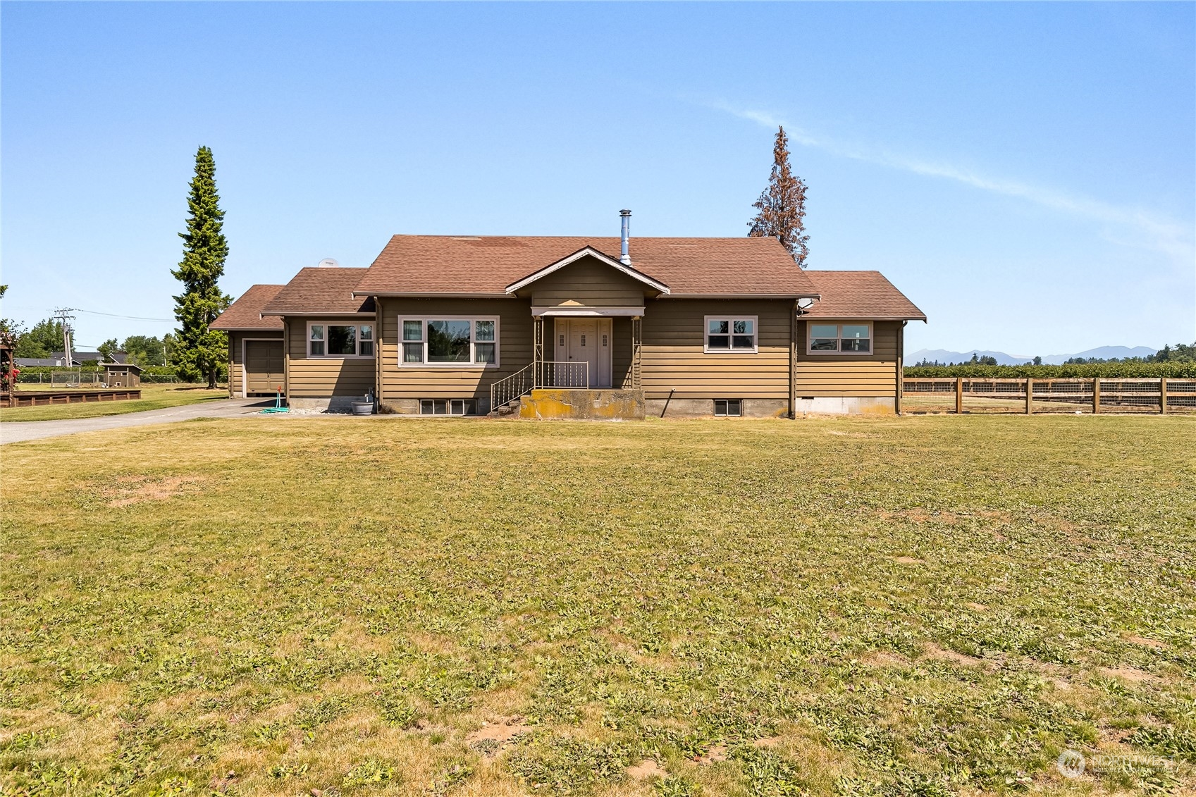 1520 East Badger Road Lynden, WA 98264 - Photo 1 of 36 a front view of a house with a yard