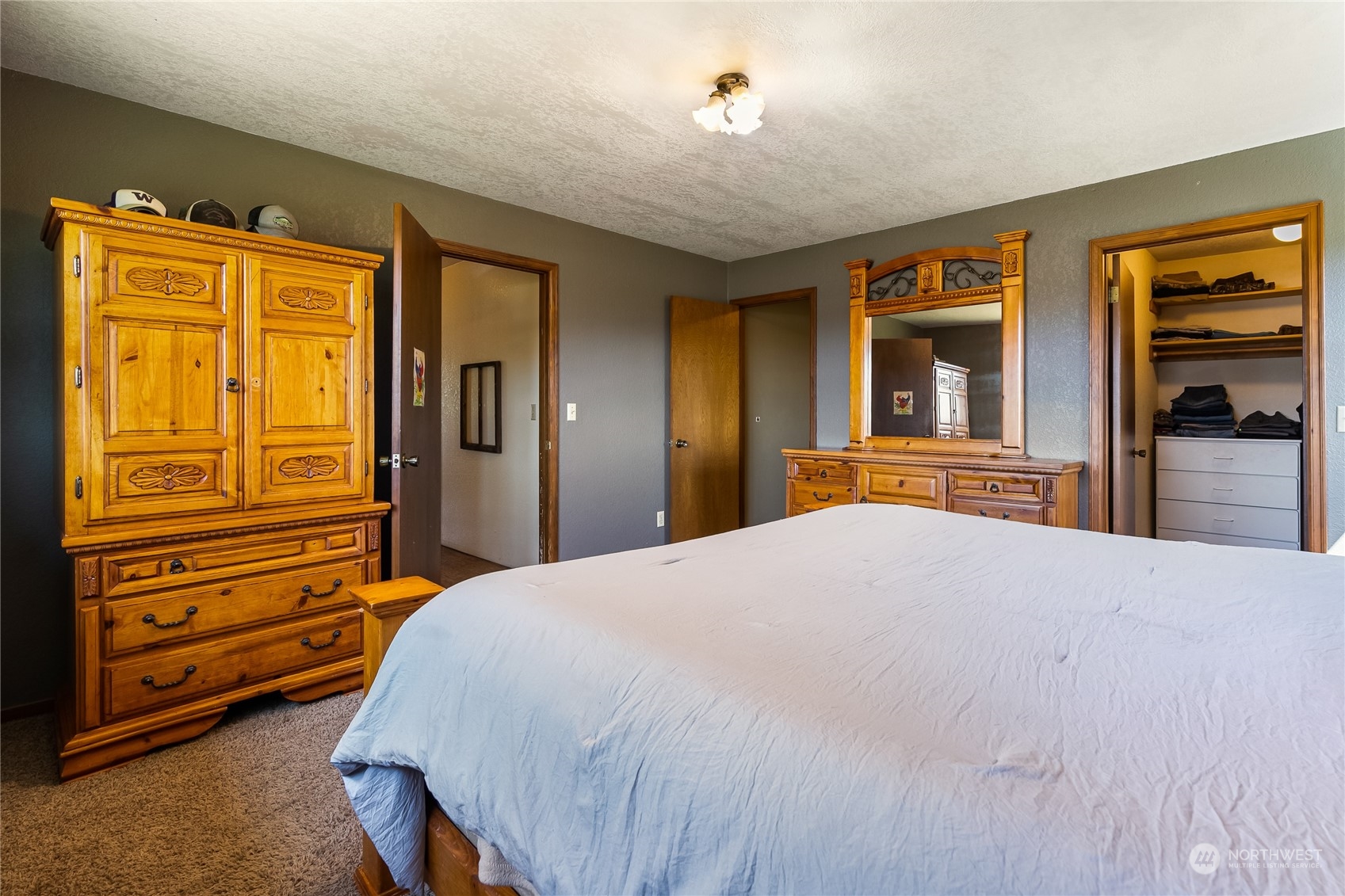 1520 East Badger Road Lynden, WA 98264 - Photo 15 of 36 a bedroom with a bed and a dresser