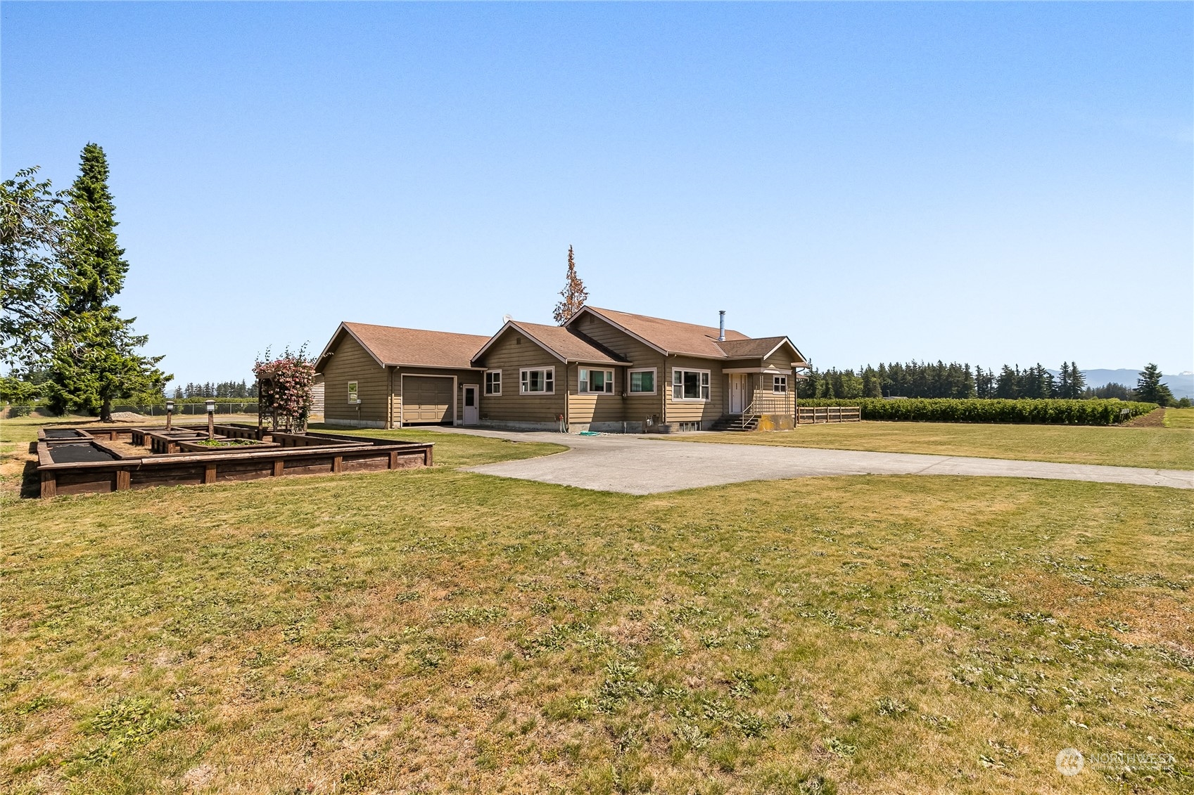 1520 East Badger Road Lynden, WA 98264 - Photo 36 of 36 a view of a swimming pool with lawn chairs and large trees