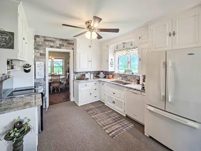 a kitchen with cabinets and window