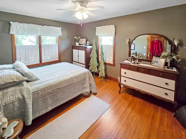 a bed sitting in a bedroom and chandelier