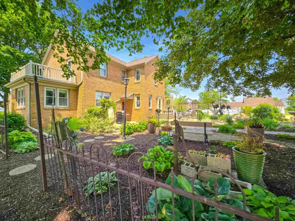 an aerial view of a house with a garden and lake view